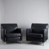 A Pair of Black Leather Armchairs