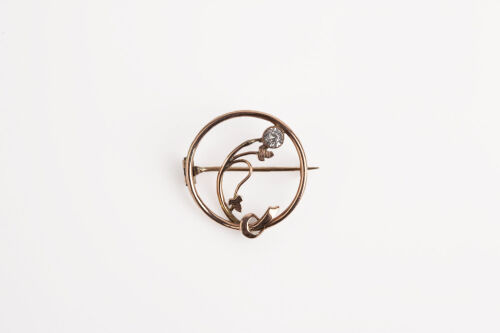 A Rose Gold Tone Brooch