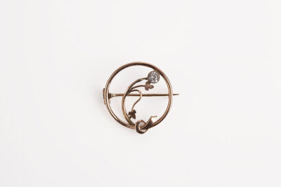 A Rose Gold Tone Brooch