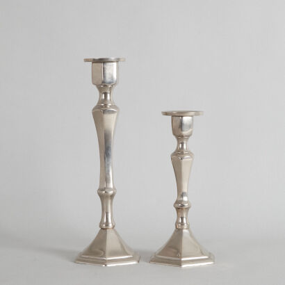 A Pair Of Polished Cast Aluminum Candlestick Holders