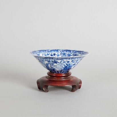 A Chinese Blue and White Barbed-Rim Saucer and Wood Stand (Da Ming Xuande Nian Zhi Mark)