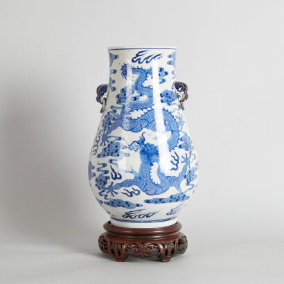 A Chinese Qing Dynasty Blue and White 'Dragon' Vase with two handles and wood stand (Da Qing Guangxu Nian Zhi Mark)