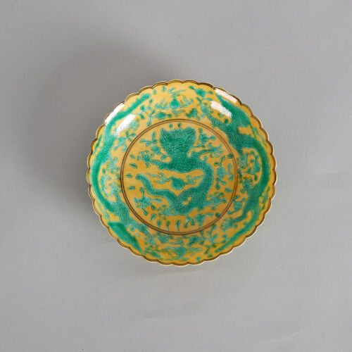 A Chinese Qing Dynasty Yellow-Ground Green-Enamel Barbed-Rim 'Dragon' Saucer (Da Qing Qianlong Nian Zhi Mark)