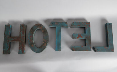 A Vintage Pressed Steel Hotel Sign