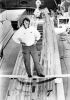 PHIL DOYLE Peter Blake stands atop the unfinished mast of his racing trimaran Steinlager One