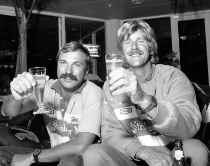 PHOTOGRAPHER UNKNOWN Mike Quilter and Peter Blake toast their inaugural Around Australia yacht race victory