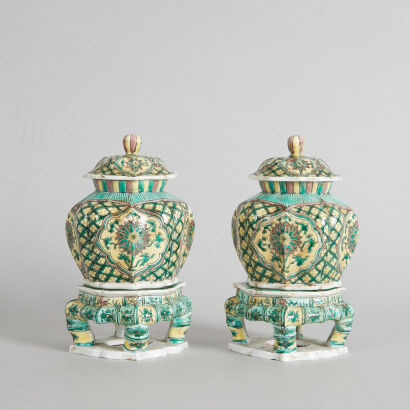 A Pair of Chinese Famille Verte Lidded Jars with bases