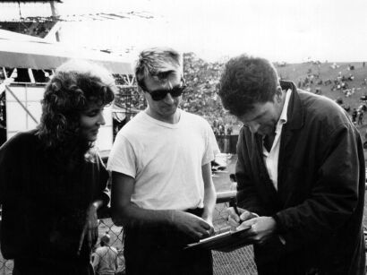 Karyn Hay, Neil Finn, and Tim Finn signing the petition for New Zealand music quotas