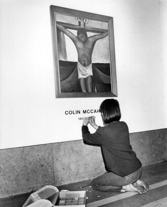 MARTIN HUNTER Louise Pether, exhibitions manager at the National Art Gallery puts the finishing touches to a Colin McCahon exhibit