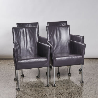 A Set Of Four Leather Dining Chairs On Castors