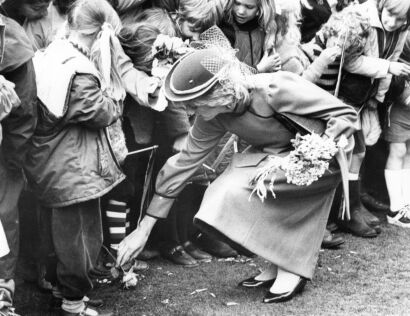 Princess Diana picks up rose given to her in Queen Elizabeth Park in Masuerton