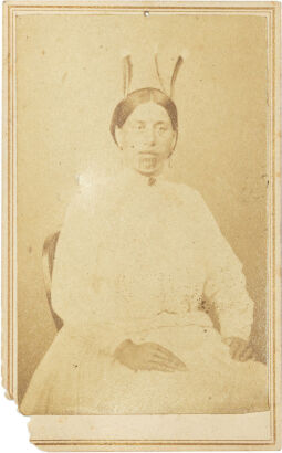 AMERICAN PHOTOGRAPHIC COMPANY AUCKLAND Portrait of Māori woman seated in Victorian dress with moko