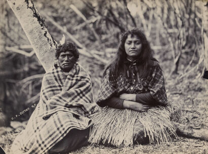 C. P. COTTIER, NEW PLYMOUTH Photograph of two Ngā Māhanga women, one wearing white feathers, near Puniho marae