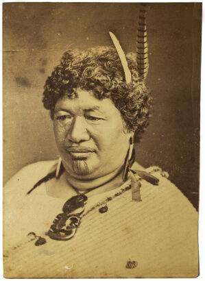 ELIZABETH PULMAN, AUCKLAND Portrait of a Māori woman with moko, pendant earrings and ribbon, hei tiki and korowai