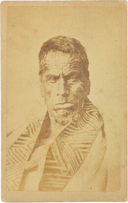 UNKNOWN PHOTOGRAPHER Portrait of a Māori man with moko wearing a Kaitaka aronui with taniko border