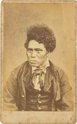 UNKNOWN PHOTOGRAPHER Portrait of a Māori man with short curly hair and European garments