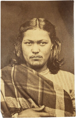 UNKNOWN PHOTOGRAPHER Portrait of a Māori woman with moko kauae wrapped in tartan blanket