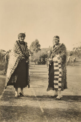 UNKNOWN PHOTOGRAPHER Dame Whina Cooper and companion both wearing kahu hurhuru, standing on a sports ground