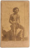 UNKNOWN PHOTOGRAPHER Portrait of Aboriginal man with headband, nose bone, string armbands and woven girdle with apron, holding a split stick