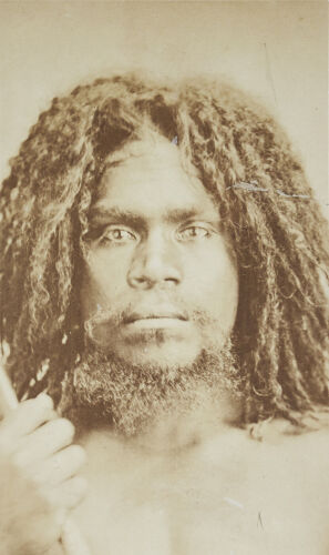 UNKNOWN PHOTOGRAPHER Portrait of young Aboriginal man holding stick