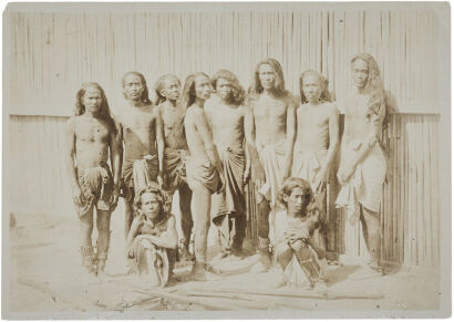 UNKNOWN PHOTOGRAPHER Ten Burmese men standing in front of a bamboo wall