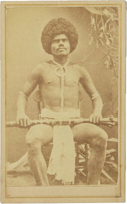 F. H. DUFTY, LEVUKA Portrait of Fijian Kai colo mountain warrior with Boar's tusk necklace and arm bands holding a rootstock club