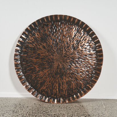 A Large Circular Copper Wall Hanging