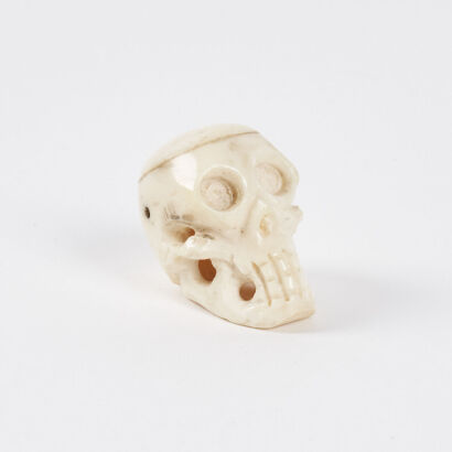 A Zora Bell-Boyd Hand Carved Bone Skull Pendant