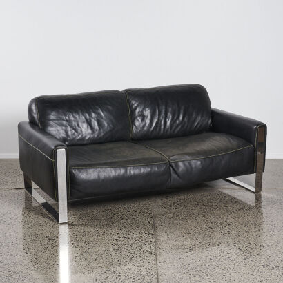 A Black Leather Couch With Stainless Legs