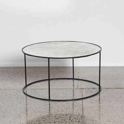 A Round Coffee Table With A Black Steel Base with Mirrored Top