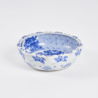 A Japanese Blue and White 'Floral and Bird' Octagonal Bowl decorated with panels (chip on rim)