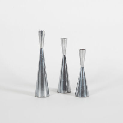 A Set Of Three Pewter Candle Stick Holders