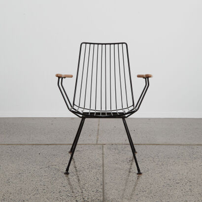 A Retro Wire Frame Chair With Wooden Arms