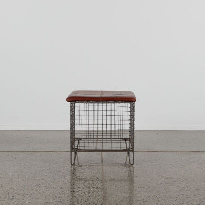 A Wire Basket Stool With Leather Cushion