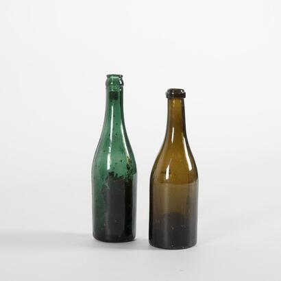 A Pair Of Green Antique Bottles
