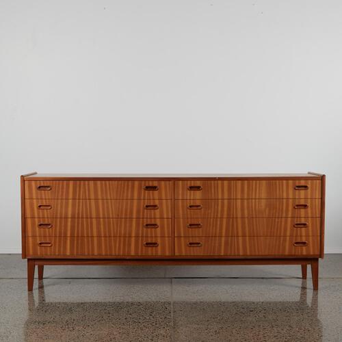 A Mid Century Teak Veneer Set Of Drawers With Eight Drawers