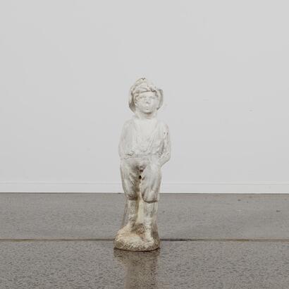 A Concrete Statue Of A Boy