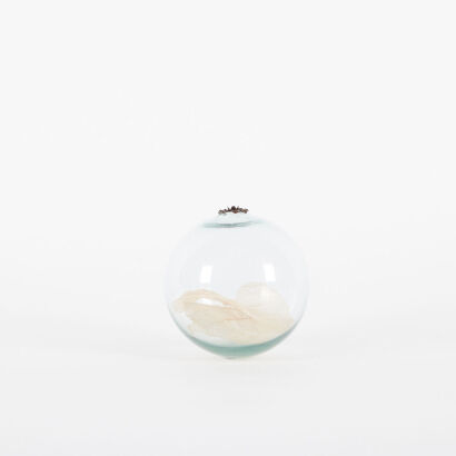 A Decorative Glass Ball With Leaves