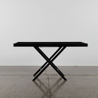 A Trestle Table In Black Timber With Folding Base
