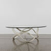 A Circular Glass Coffee Table With Organic Ring Base
