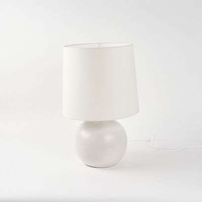 A Round Bone Pottery Lamp With Linen Shade