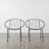 A Pair Of Black Wire Coolie Chairs