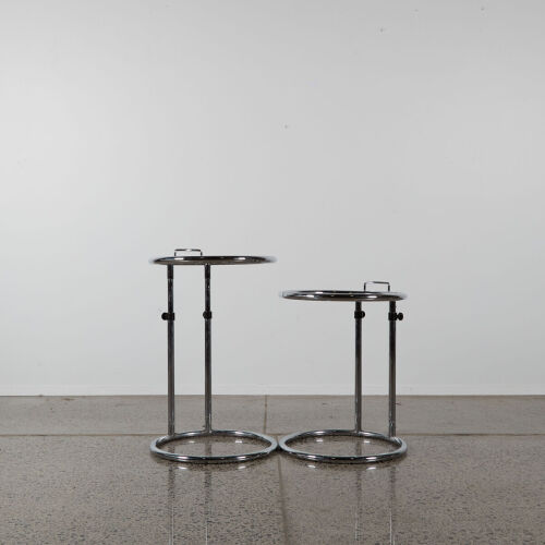 A Pair Of Chrome And Glass Adjustable Side Tables