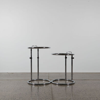 A Pair Of Chrome And Glass Adjustable Side Tables