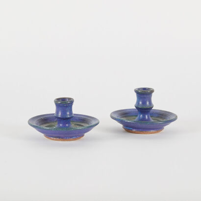 A Pair Of Glazed Ceramic Candleholders With Glass Glaze