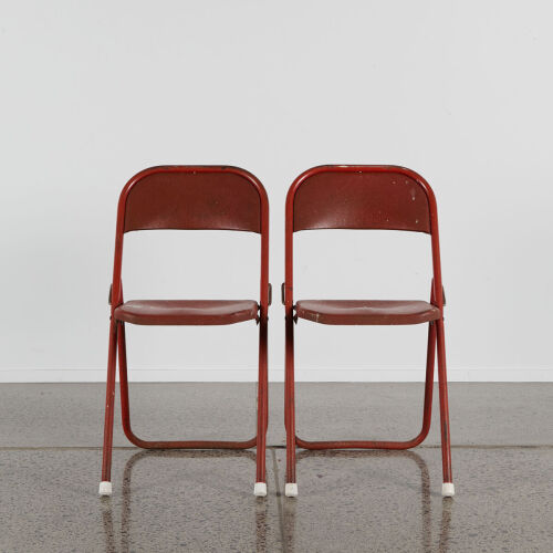 A Pair Of Rustic Red American Folding Metal Chairs