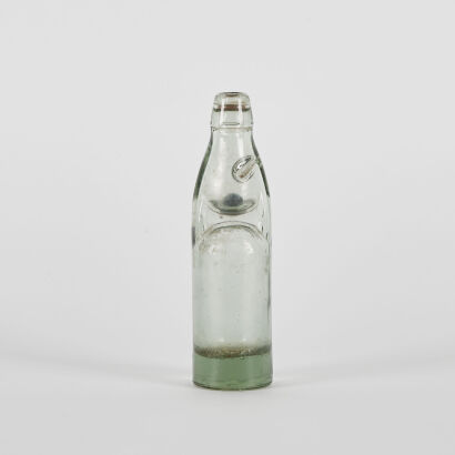 A Vintage Clear Glass Soda Bottle With Marble