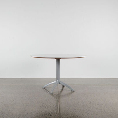 A Circular Table With An Aluminium Base