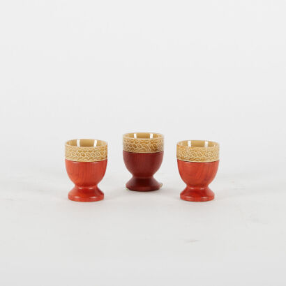 A Trio Of Mid Century Japanese Teak And Mustard Ceramic Egg Cups