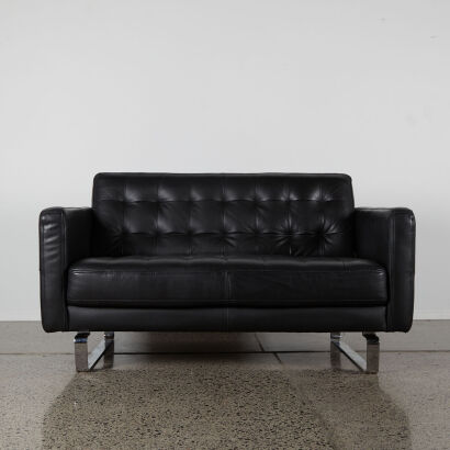 A Black Two Seater Couch With Metal Sleigh Base